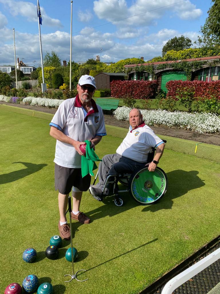 Chris cleaning a bowl for Ray (in the wheelchair) who played 9 ends (Roy played the other 9 ends). Also a nice view of the surrounding gardens.